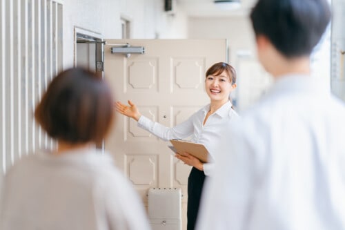 female real estate agent showing clients a home