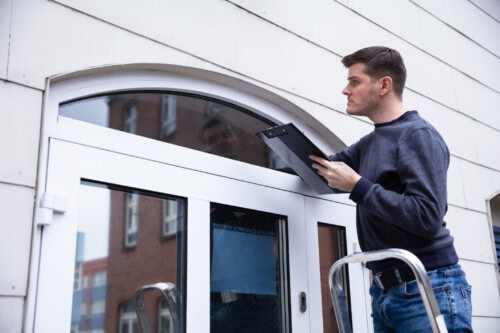 real estate appraiser examines window