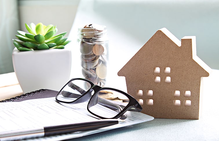 Items on the desk of a person who's researching real estate jobs and their salaries