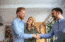 Young couple getting new house keys from a real estate sales agent, just one of many real estate careers available