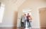 family opening door in to new home