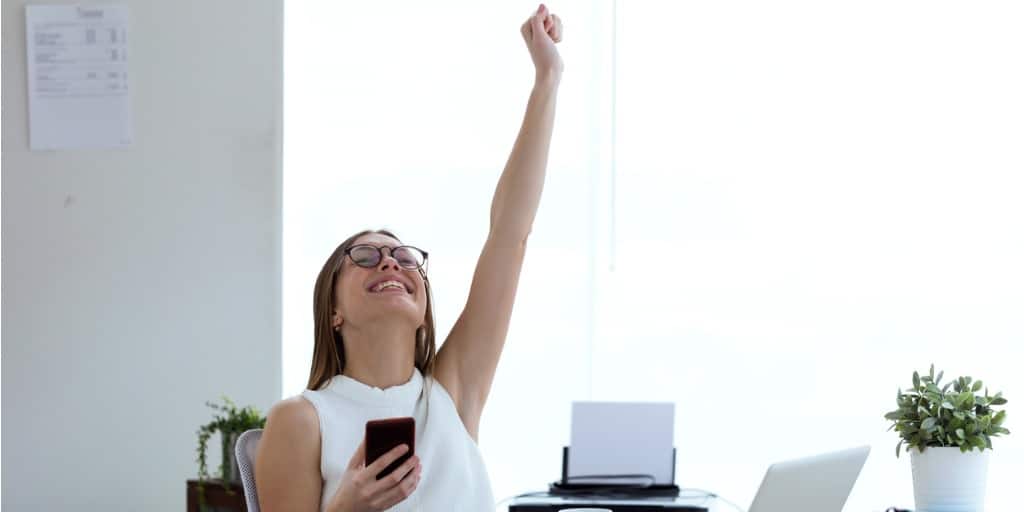 Young woman smiling victoriously after passing her real estate exam