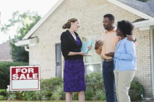 real estate agent showing house to clients