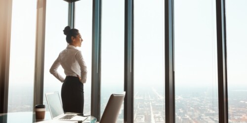 business woman looking out over the city