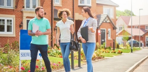 first-time homebuyers looks at housing with real estate agent