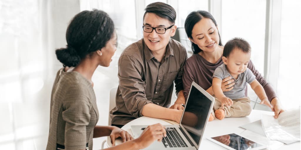 real estate agent teaching family about home mortgages