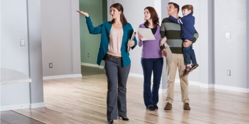 real estate agent showing house to family