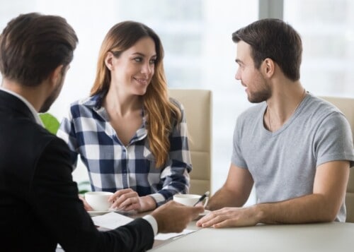 happy millennial couple visiting realtor buying first home