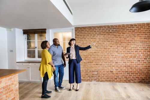 new real estate agent showing couple a house