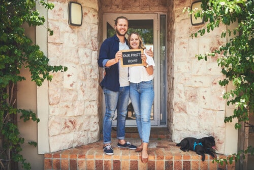 Portrait of a young couple holding a chalkboard with 