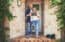 Portrait of a young couple holding a chalkboard with "our first home" written on it
