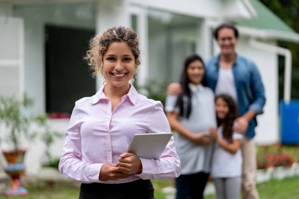 Real estate agent showing a family a suburb house