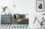 Bicycle and poster in cozy living room interior with wooden table near brown couch and grey cabinet
