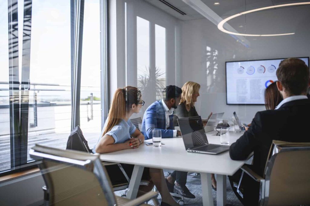 Executive Team Watching Video in Office Conference Room