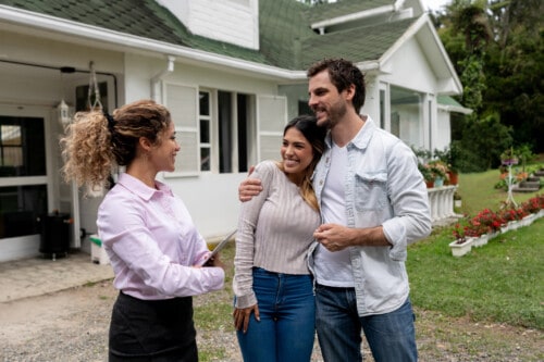 Real estate agent showing a couple a beautiful house