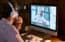 Male student wearing headphones taking online course training, watching webinar, remote seminar university class, virtual learning with social distance web teacher, tutor or coach on computer screen.
