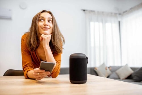 Woman with smart wireless column at home