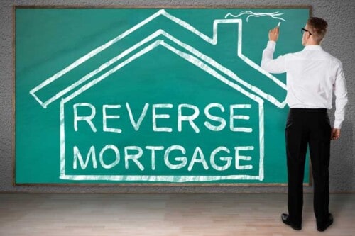 Man writes reverse mortgage on chalkboard