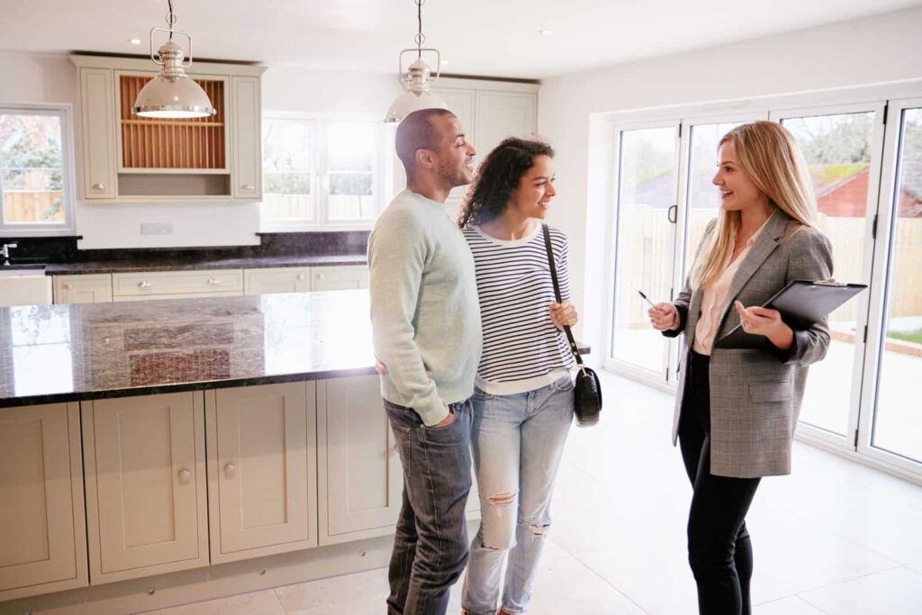 New York real estate agents showing a house to clients after getting their license