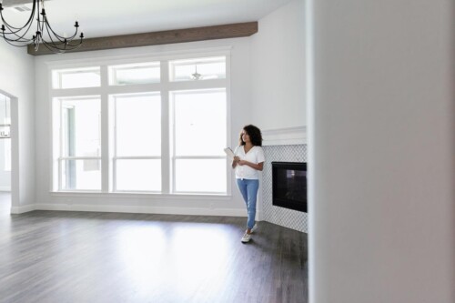 Woman examines home while considering a real estate career.