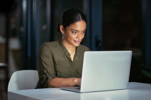 Woman concentrates on studying for the real estate exam. How difficult is it to get a real estate license?