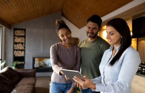 Real estate agent shows couple his real estate website