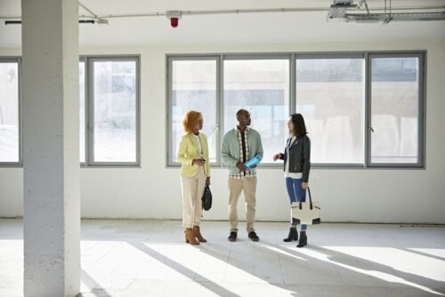 real estate agent shows commercial property to business owners