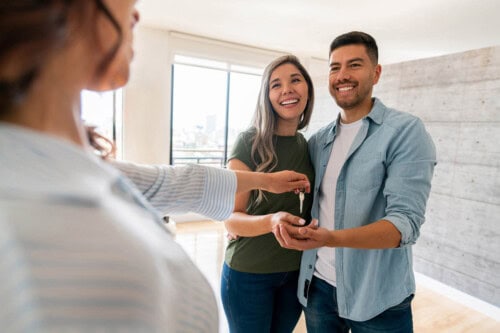 broker giving key to new homeowners