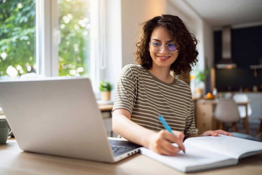 woman at laptop preparing for real estate exam